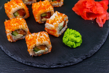 Sushi rolls Philadelphia on a black slate