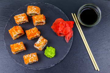 Sushi rolls Philadelphia on a black slate. Top view