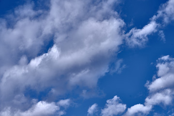 white clouds floating in the blue sky