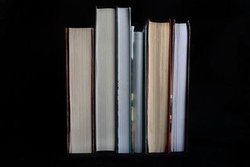 Old books on the black background.