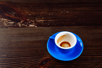 Dirty cup after coffee on a wooden table.