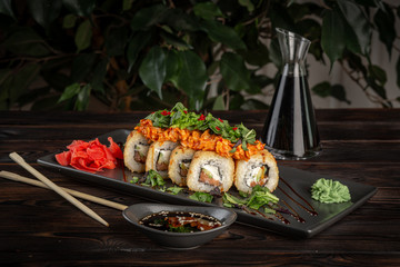 set of sushi rolls on a rectangular black plate