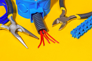 Spare parts, tools and wires for replacement or repair of electrical equipment on yellow background