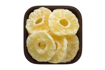 candied fruit, rings pineapple in square bowl isolated on white background. organic food, top view.