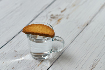 A bottle of water, crackers, drying on the background of boards for a healthy lifestyle.