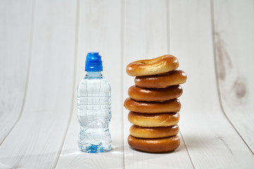 A bottle of water, crackers, drying on the background of boards for a healthy lifestyle.