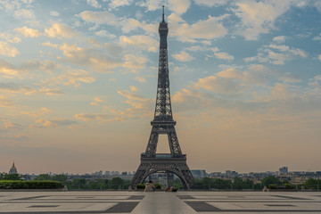 Paris, France - 04 25 2020: View of the Eiffel Tower from the Trocadero esplanade with a seated couple during the coronavirus period
