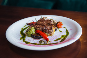 Juicy steak with vegetables , cooked on the grill.