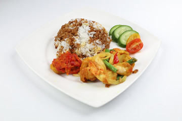 Turmeric Friend Chicken with vegetable white rice topped with dark sauce ayam goreng kunyit
