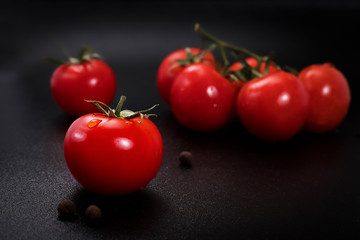 red tomatoes on black background