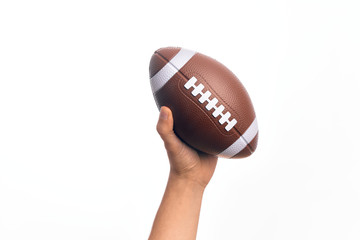 Hand of caucasian young sporty man holding football ball over isolated white background