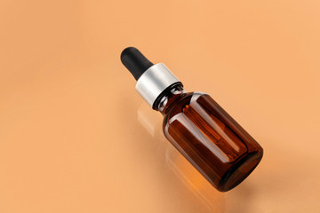 Skincare serum bottle on a light beige background close up