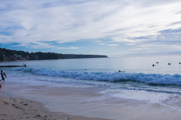 Surfing on the island of Bali in the Pacific and Indian Ocean. Male surfers engage in active sports on sick waves