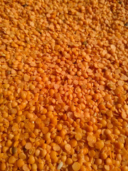 Red raw organic lentils texture. Food ingredient background. Natural