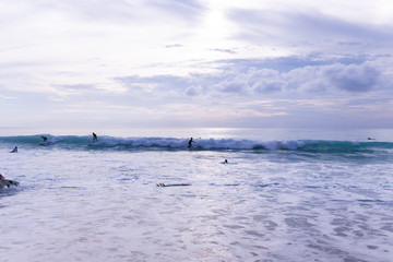 Surfing on the island of Bali in the Pacific and Indian Ocean. Male surfers engage in active sports on sick waves