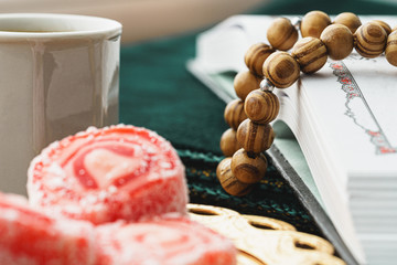 Coffee cup with oriental sweets on wooden table close up