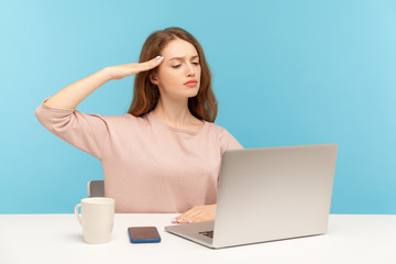 Yes sir! Responsible employee woman giving salute, listening to order and looking at laptop screen on video call, online conference from home office. indoor studio shot isolated, blue background