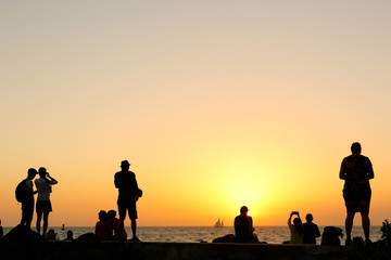 A Group of Tourists Watching Sunset at Fort Zachary Taylor Historic State Park, better known as Fort Taylor, Florida USA