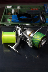 Obraz premium Fishing equipment on a old wooden table. Sport and recreation concept