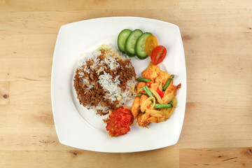 Turmeric Friend Chicken with vegetable white rice topped with dark sauce ayam goreng kunyit