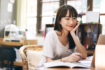 Asian teenager woman stay at home use internet for work and study