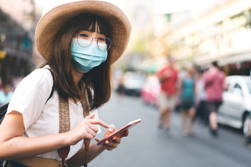 Young asian woman travel in city with mask for prevent from virus.
