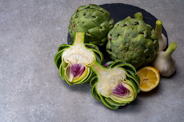 Big ripe uncooked green globe artichoks vegetables