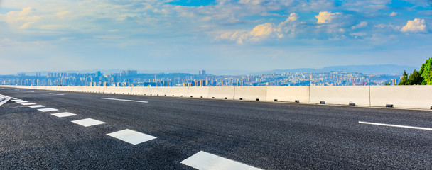 Empty asphalt road and Chongqing city skyline and buildings at sunset,China.