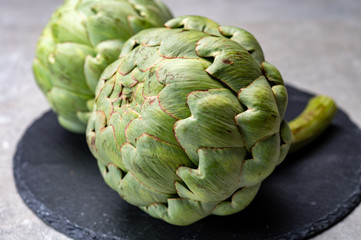 Fototapeta premium Big ripe uncooked green globe artichoks vegetables