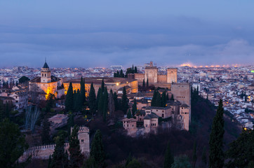 Fototapeta na wymiar View of the Alhambra and the Generalife and the city of Granada from the viewpoint of the Silla del Moro at sunrise.