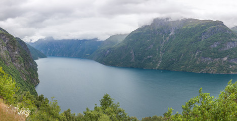 Fototapeta na wymiar Geiranger fjord, Beautiful Nature Norway. It is a 15-kilometre, 9.3 mi long branch off of the Sunnylvsfjorden, which is a branch off of the Storfjorden