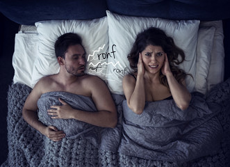 Girl has difficulty to sleep due to snore noise of the boyfriend. concept of discomfort and...