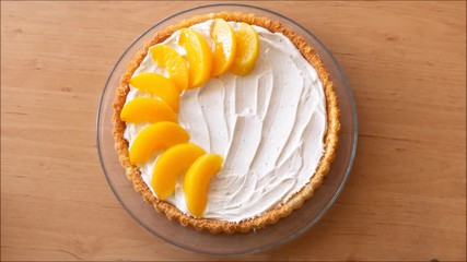 Process of decorating fruit tart with cream and fresh fruits in stop motion