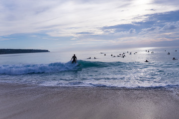 Surfing on the island of Bali in the Pacific and Indian Ocean. Male surfers engage in active sports on sick waves