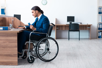 Young male employee in wheel-chair
