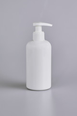 A pack shot of shampoo, soap bottle in isolated grey background.