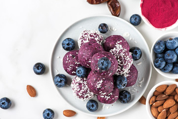 Raw vegan homemade dessert. Blueberry and acai energy balls or bites with fresh berries. top view
