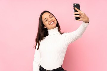 Young woman with a mobile over isolated background