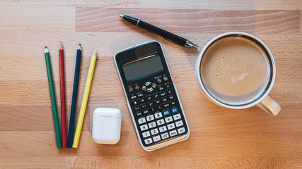 office and school supplies on wooden table