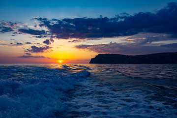 Raging sea waves at sunset in the ocean. Storm clouds on the sea.