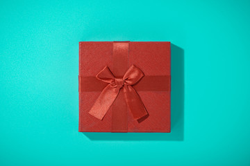 flat lay photo of red gift box on blue background