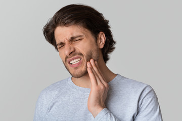 Dental problems concept. Man suffering from toothache