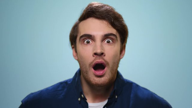 Surprised man looking at camera. Handsome guy with wow expression