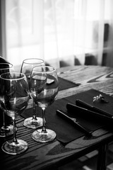 Four wine glasses stand on a table