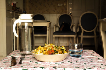 stir fry salad, asian style cooked. Salad with cauliflower, chicken, onion, broccoli and lettuce served on a plate