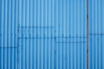 Texture background of blue corrugated metal fence.