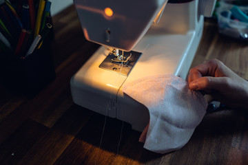Closeup of a sewing machine. sew protective face masks. sewing at home. tailor pins in fabric....