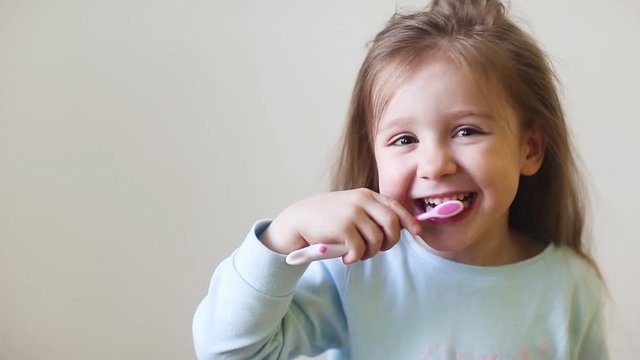 child brush their teeth. dental hygiene. happy little girl