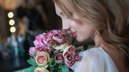Naklejka premium Beautiful young girl with a bouquet of flowers