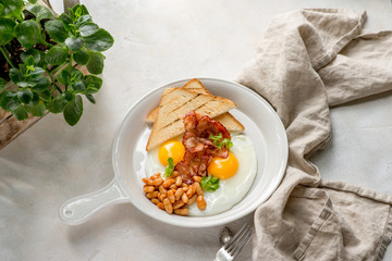 Breakfast with ham egg beans toast daylight cafe restaurant towel american wooden table on stone